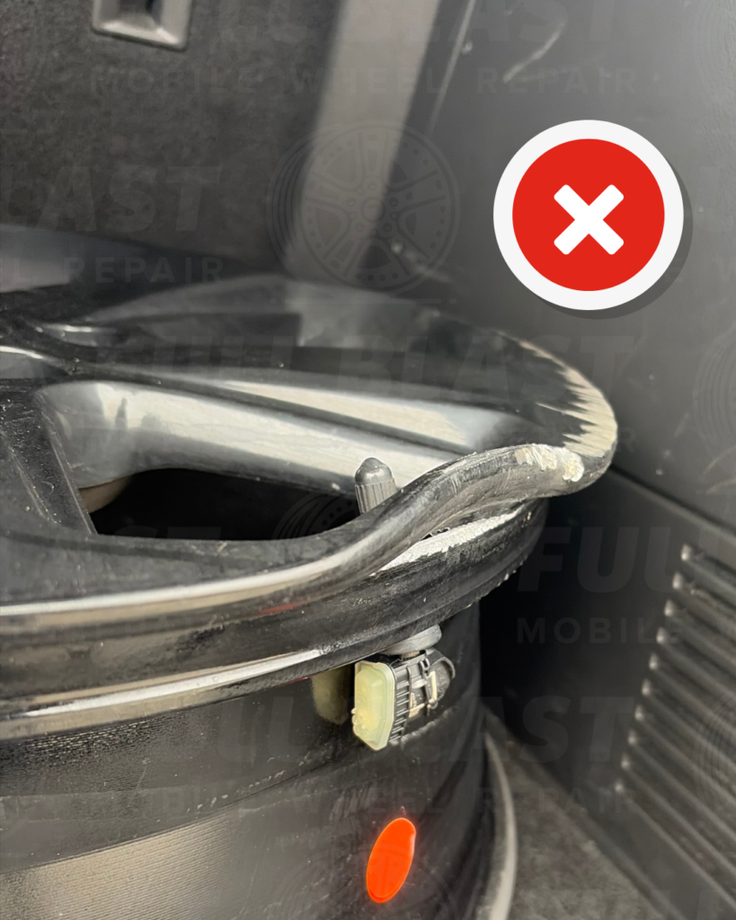 Bent wheel on the front face of the rim showing severe deformation requiring wheel replacement